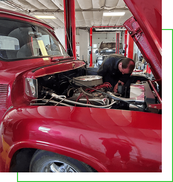 Mechanic Fixing Red Vintage Vehicle